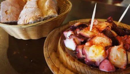 Plate of Pulpo a la Gallega, traditional Galician octopus with paprika and olive oil, a popular dish along the Camino de Santiago.